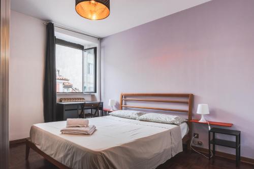a bedroom with a bed and a window at [Piazza Goldoni] Suite Mazzini *Free WiFi* in Trieste