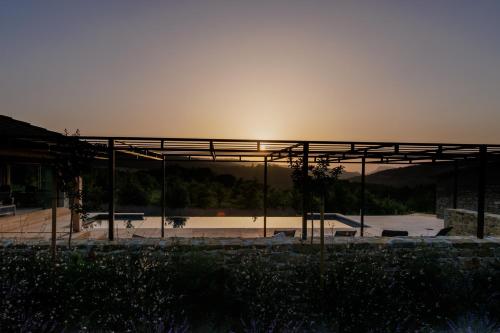 a view of a building with the sunset in the background at Domaine de Chabanne in Crupies