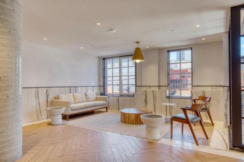 a living room with a couch and a table at Dumbo 1br w gym roof nr TimeOut Building NYC-958 in Brooklyn