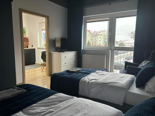 En eller flere senge i et værelse på Apartament Black