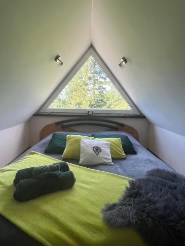 a bed in a small room with a large window at HELLO GIEWONT in Zakopane