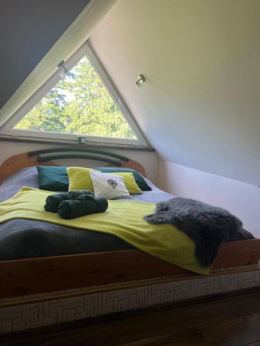 a bedroom with a bed with a window at HELLO GIEWONT in Zakopane