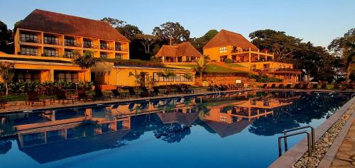 a pool of water in front of a building at Kaazi Beach Resort in Kampala