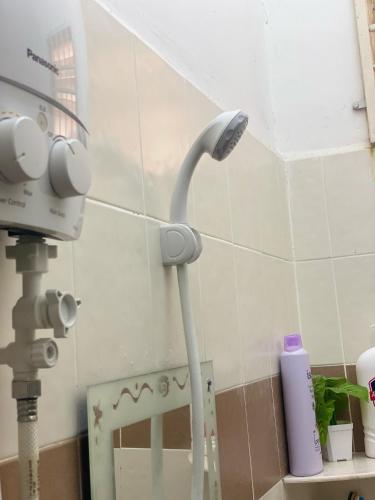 a shower head on a wall in a bathroom at Homestay Desa Tikam batu in Sungai Petani