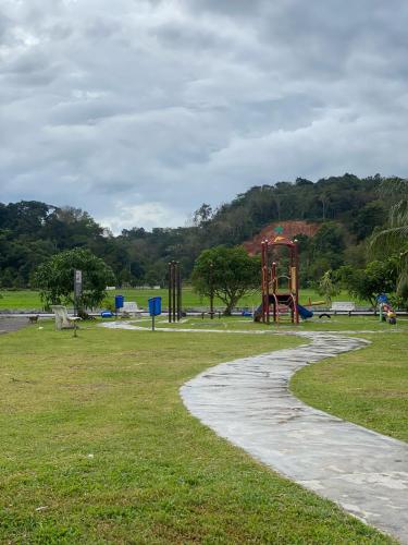 a park with a playground with a slide at Homestay Desa Tikam batu in Sungai Petani