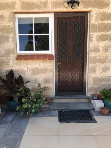 a front door of a house with potted plants at Clare to Spalding character escape in Spalding