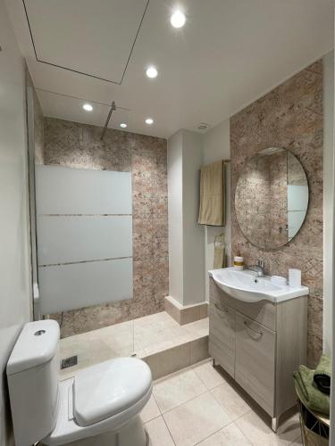 a bathroom with a toilet and a sink and a mirror at Syntagma Hideaway Luxury Apt in Athens