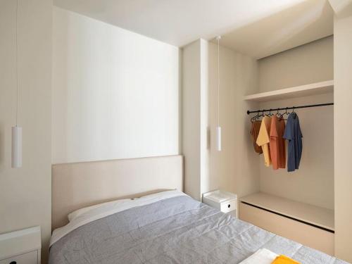 a small bedroom with a bed and a closet at Hoppersgr- Amazing apt in the heart of Athens - 1 in Athens