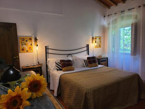 a bedroom with a bed with sunflowers on it at Podere Piana in Reggello