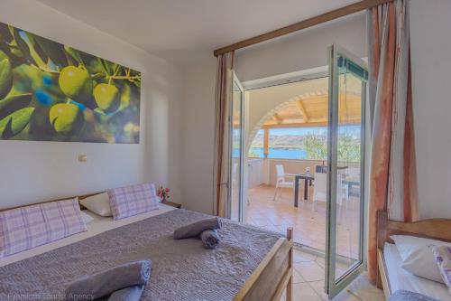 a bedroom with a bed and a sliding glass door at Katarina 1 in Zubovići