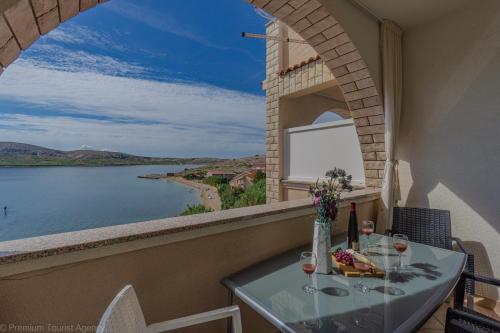 a balcony with a table and a view of the water at Katarina 1 in Zubovići