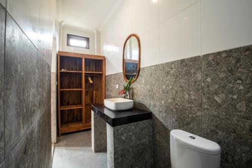 a bathroom with a sink and a mirror at DADEKA Canggu in Canggu