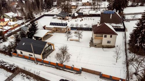 an aerial view of a snow covered yard with a train at Casa Tinca 1 in Izvoru Mureşului
