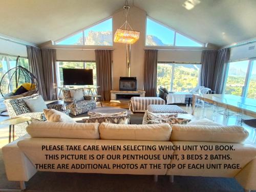 a living room with a couch and a table at Mount Rhodes Guesthouse, three separate units, please select either three bedroom, two and a half bedroom or one bedroom in Cape Town