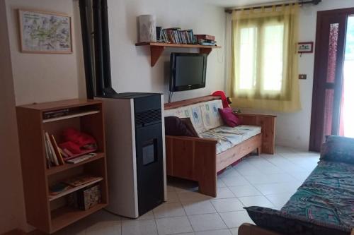 een woonkamer met een kinderbed en een televisie bij La Casa nelle Stelle 