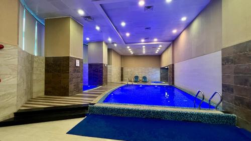 a large swimming pool in a room with at Centaurus Apartment Mountain View Three Bed in Islamabad