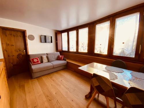 een woonkamer met een bank en een tafel bij Charlotte Lodge Cervinia in Breuil-Cervinia