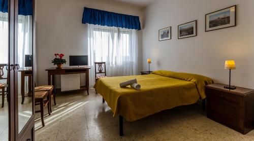 a bedroom with a bed and a desk with a computer at Hotel Antico Acquedotto in Rome