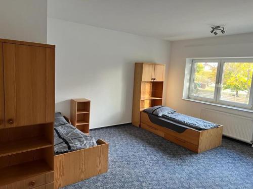 a room with two beds and a window at Wiehengebirgs Fernblick App 2 in Bad Essen