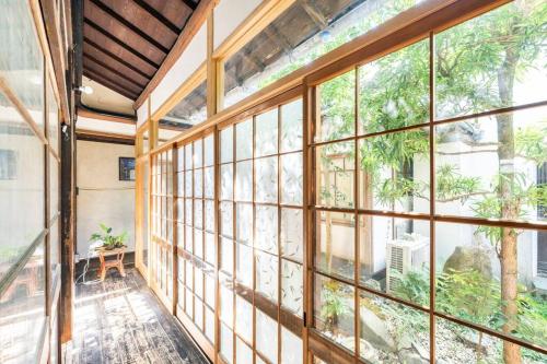an empty room with large windows in a building at まろや四季 in Ōzu