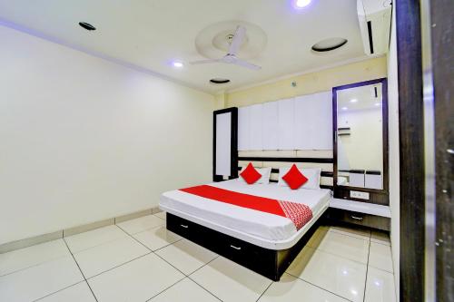 a bedroom with a large bed with red pillows at OYO SPOT ON Hotel My Lord in Bhopal