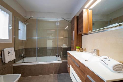 a bathroom with a sink and a shower at Villa near San Antonio sleeps 10 in Ses Paisses