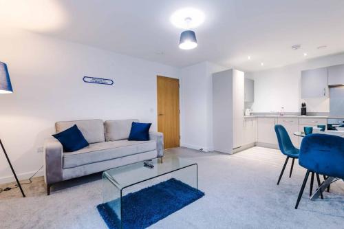 a living room with a couch and a table at Luxury balcony apartment near Manchester City Centre - Free Secure Parking - Self-Check In in Manchester