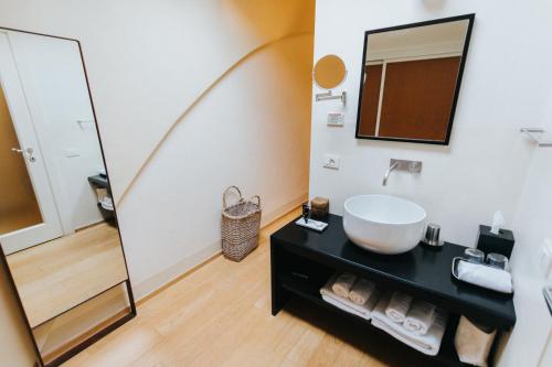 a bathroom with a sink and a mirror at Locanda Palazzone in Orvieto