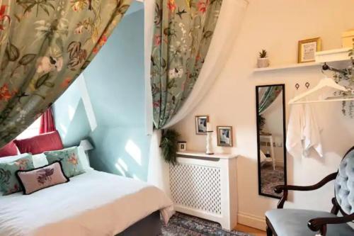 a bedroom with a bed and a mirror at The Maple Retreat - Hampstead in London