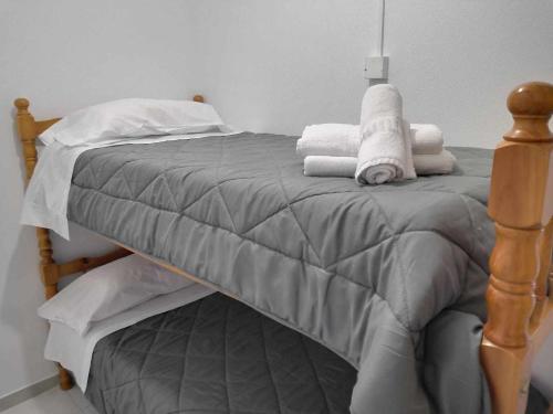 a bed with towels on it in a room at A H Rentals Carles III Apartamento 150mtrs playa in Sant Carles de la Ràpita