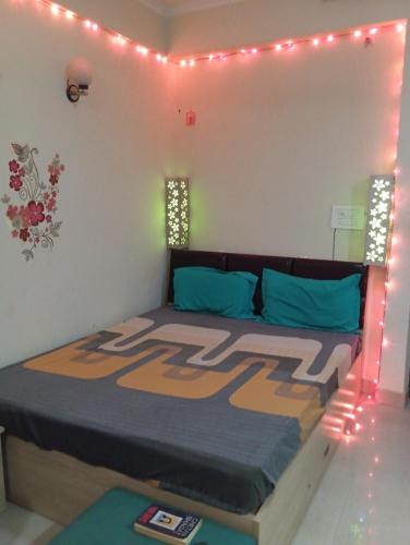 a bedroom with a bed with lights on it at Home Stay 1 in Noida