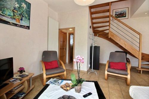 a living room with two chairs and a table at La grange de kerivoalan in Pleubian