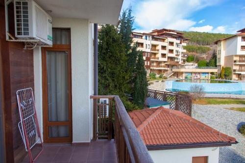 a balcony of a house with a view of a pool at Kalina Apart in Sveti Vlas