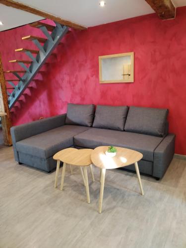 a living room with a couch and a table at Maison au calme dans un petit hameau in Verdun-sur-Garonne