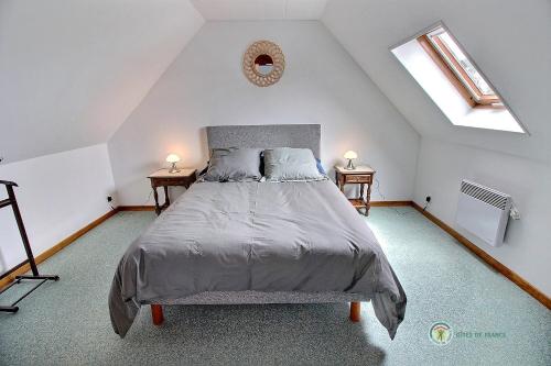 1 dormitorio con 1 cama grande y 2 mesitas de noche en Ar vag, en Ploubazlanec