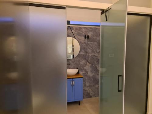 a bathroom with a sink and a mirror at Desert view studio in Beʼer Ora