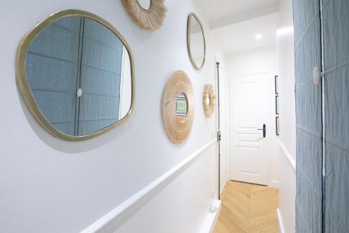 a hallway with a mirror on the wall and a door at Lovely Apartment next to Roland Garros - V90 in Paris