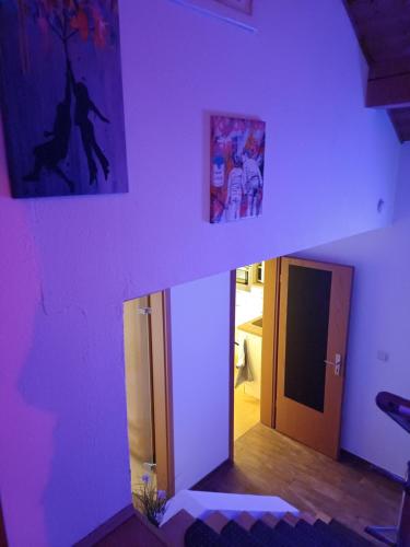 a room with purple walls and a hallway with a door at Das Tor zur Rhön in Dietlas