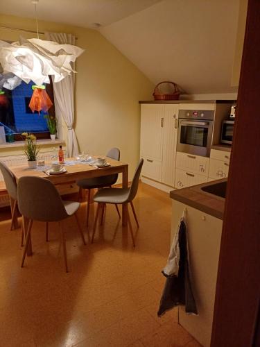 a kitchen with a table and chairs and a dining room at Das Tor zur Rhön in Dietlas