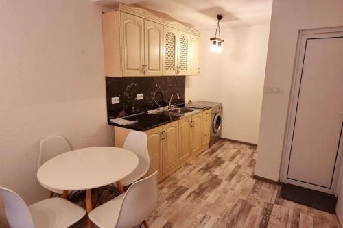 uma cozinha com uma mesa branca e cadeiras brancas em Sweet Home Apartament em Smolyan