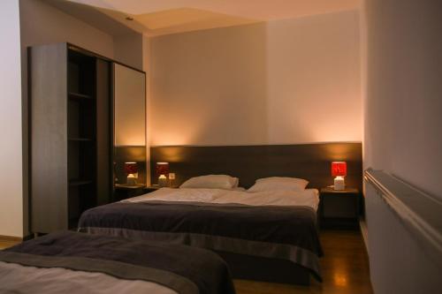 a bedroom with two beds and two lamps at Hotel & Hostel Escape in Gudauri
