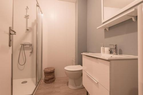 ein weißes Bad mit einem WC und einer Dusche in der Unterkunft Le safari 