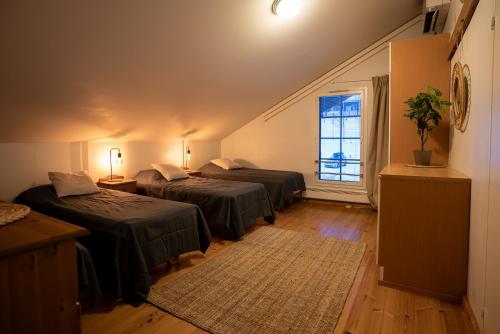 a room with two beds and a window at Hotel Tahko in Tahkovuori