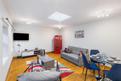 a living room with a couch and a table at Iconic London Apartment in London