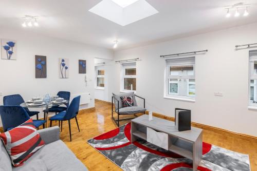 a living room with a couch and a table at Iconic London Apartment in London