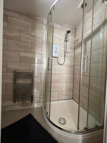 a shower with a glass door in a bathroom at One Bed Rylands Street in Warrington