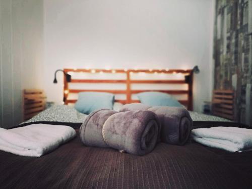 a bedroom with two beds with blankets and pillows at Felhőfészek vendégház in Verőce