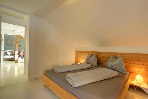 a bedroom with a bed with a wooden headboard at Appartements Nagl Nassereith in Nassereith