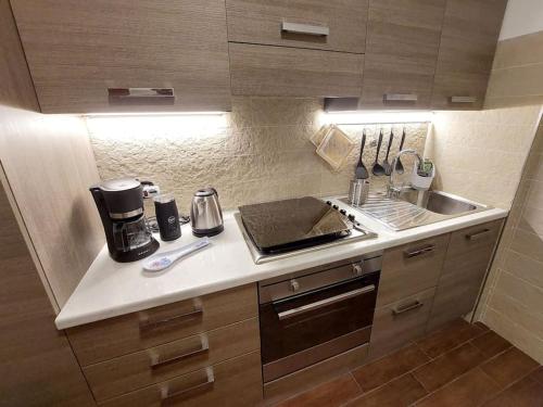 a small kitchen with a sink and a stove at Sunset House Perledo in Perledo