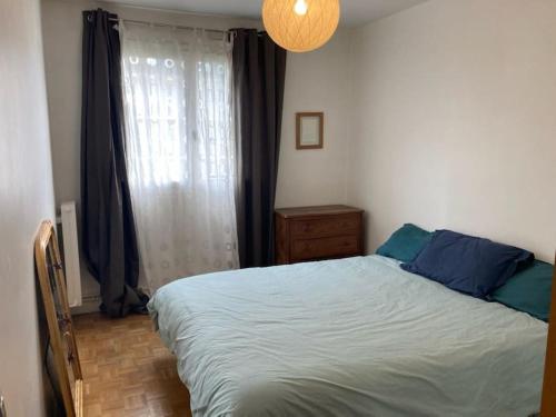 une chambre avec un grand lit et une fenêtre dans l'établissement 2 bedroom apartment with balcony / park Buttes Chaumont /Jourdain, à Paris